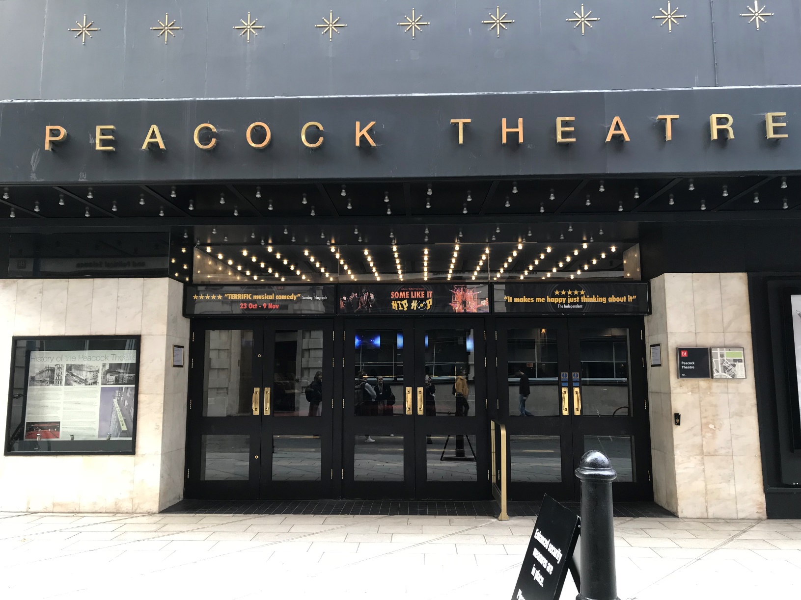 A photo of the black Peacock Theatre entrance doors