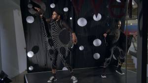 Two dancers in a window display surrounded by white orb props