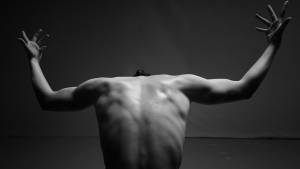 A black and white photo of an athletic person's back
