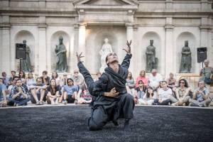 Two dancers performing outside in front of an audience