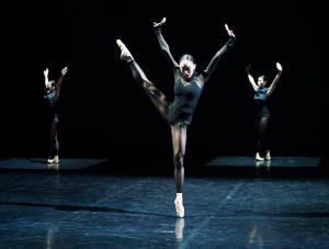 Three female ballet dancers performing onstage