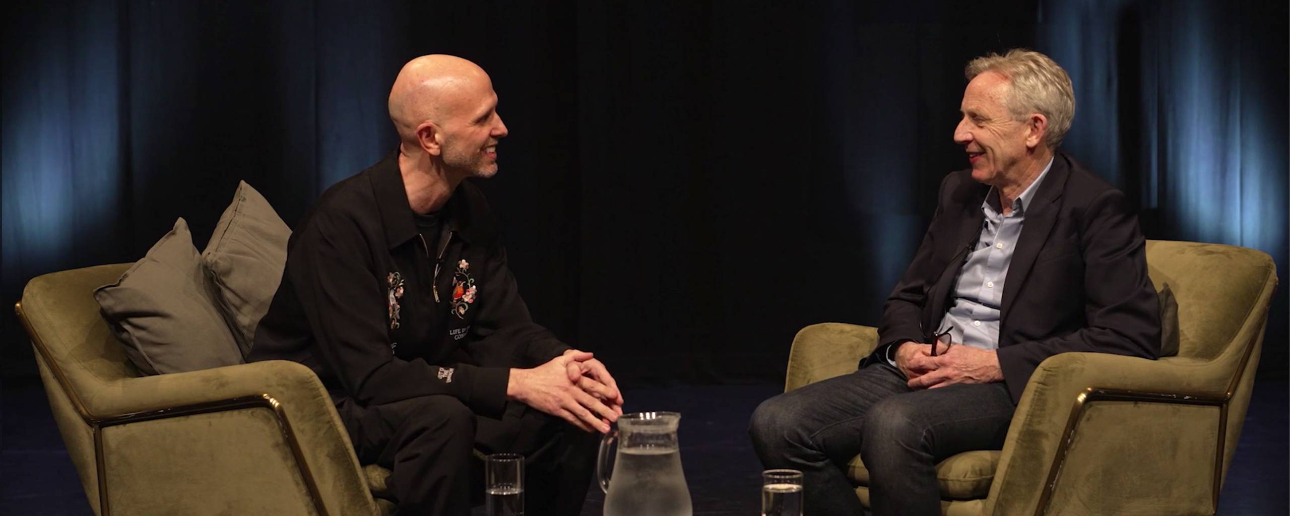 Wayne McGregor and Sir Alistair Spalding sit on stage in conversation with each other